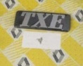 7701366370 - Emblema "TXE" (Phase 2) Guarda lamas frente
